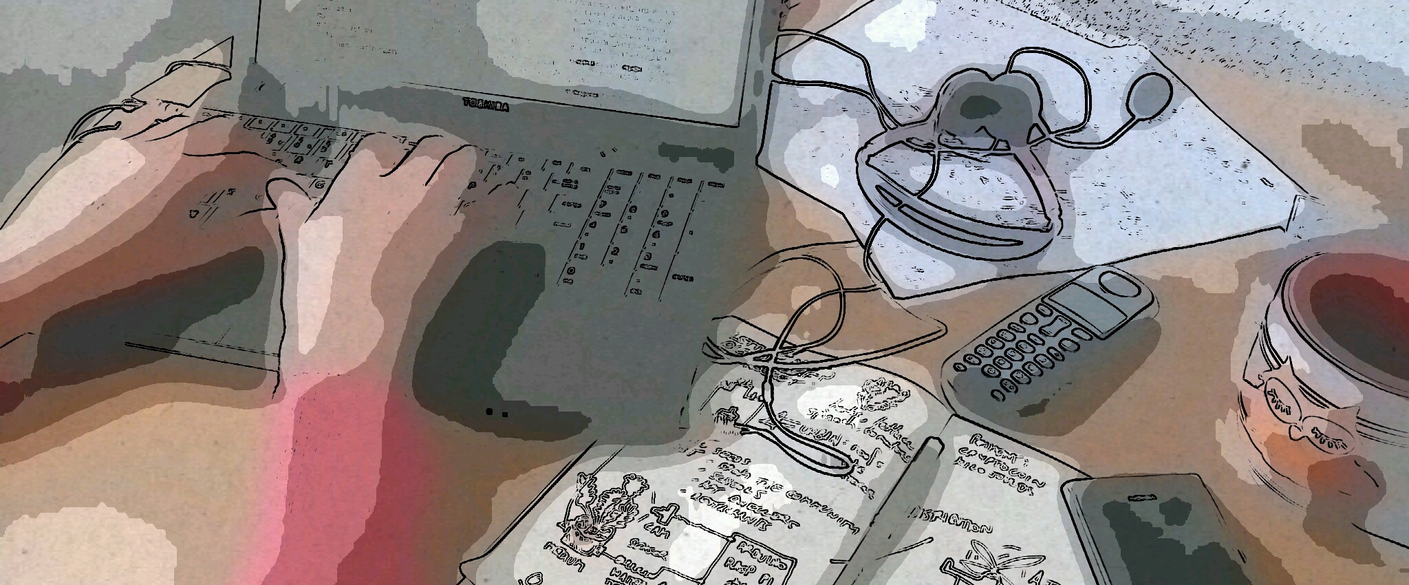 laptop being typed at with notebook and accessories on desk